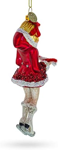 החלקה על קרח ילדה עם קישוט לחג המולד זכוכית קני קנב